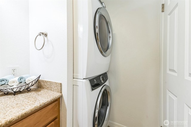 laundry room with stacked washer and dryer and laundry area