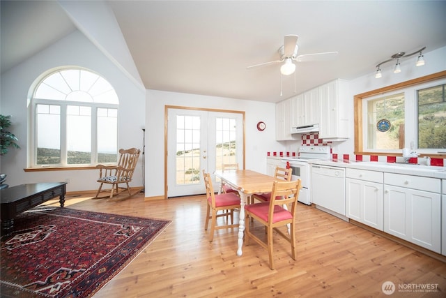 kitchen with light wood-style flooring, under cabinet range hood, white appliances, white cabinetry, and french doors