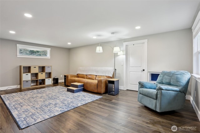 living room featuring dark wood-type flooring, recessed lighting, and baseboards