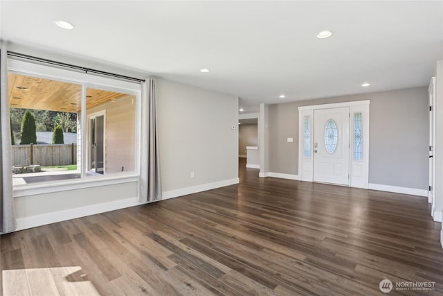 unfurnished living room featuring plenty of natural light, recessed lighting, baseboards, and wood finished floors