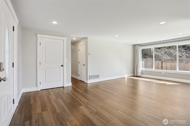 unfurnished room with recessed lighting, baseboards, visible vents, and wood finished floors