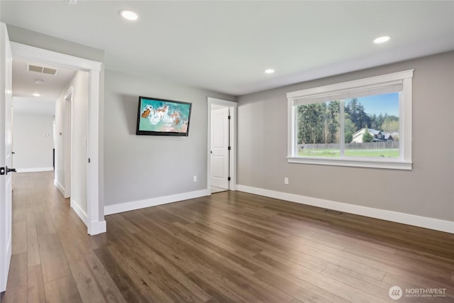 spare room with recessed lighting, baseboards, visible vents, and wood finished floors