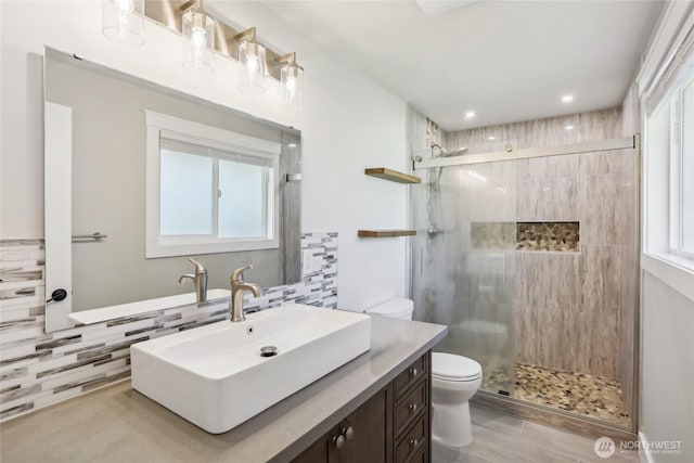 full bathroom with a wealth of natural light, toilet, and a shower stall