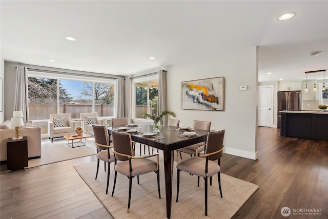 dining room with recessed lighting, baseboards, and wood finished floors