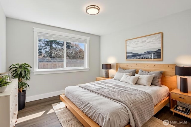 bedroom with baseboards and wood finished floors