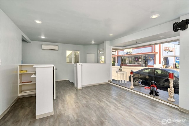 interior space featuring recessed lighting, wood finished floors, and a wall mounted AC