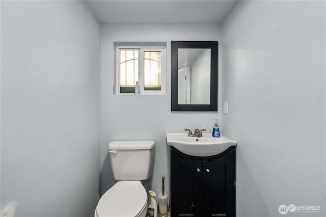 bathroom featuring toilet and vanity