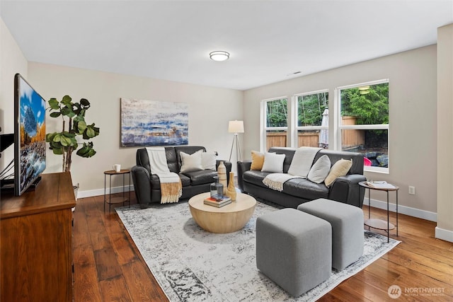 living area with visible vents, dark wood-style floors, and baseboards