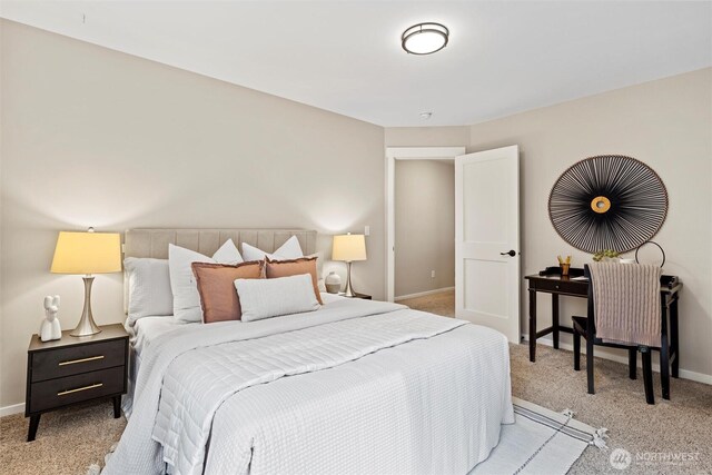 bedroom featuring baseboards and light colored carpet