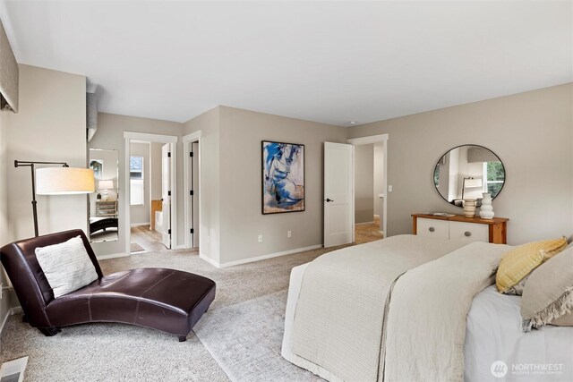 carpeted bedroom featuring baseboards and visible vents