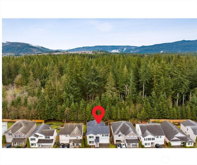 bird's eye view with a mountain view, a residential view, and a wooded view