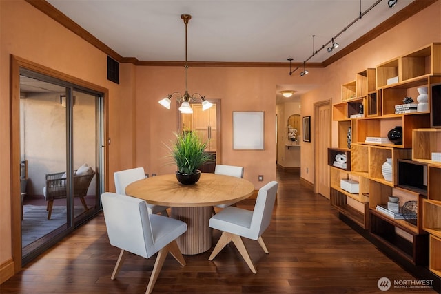 dining area with a notable chandelier, visible vents, baseboards, ornamental molding, and dark wood-style floors