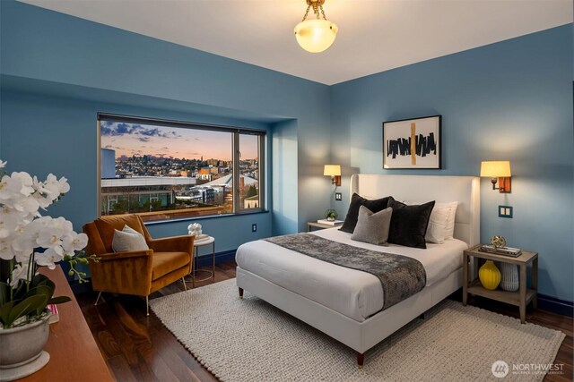 bedroom featuring baseboards and wood finished floors