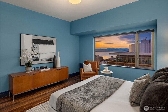 bedroom featuring dark wood-style floors and baseboards