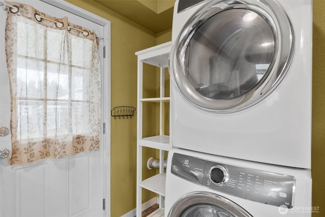 clothes washing area featuring laundry area and stacked washer and dryer