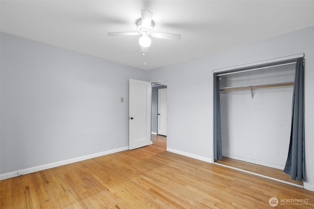 unfurnished bedroom with light wood-type flooring, ceiling fan, baseboards, and a closet