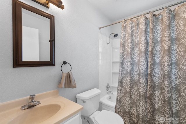 full bath with a textured wall, vanity, shower / bath combo with shower curtain, and toilet