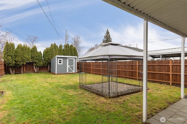 view of yard with a shed, an outdoor structure, and a fenced backyard