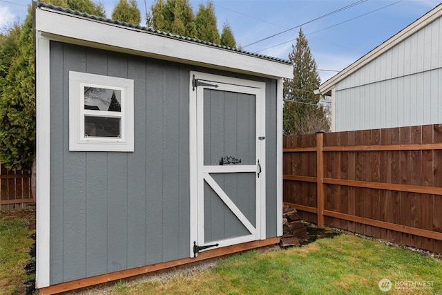 view of shed with fence