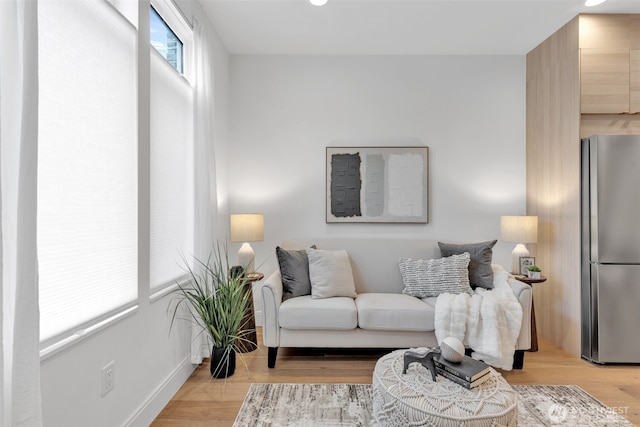 living room featuring light wood finished floors and baseboards