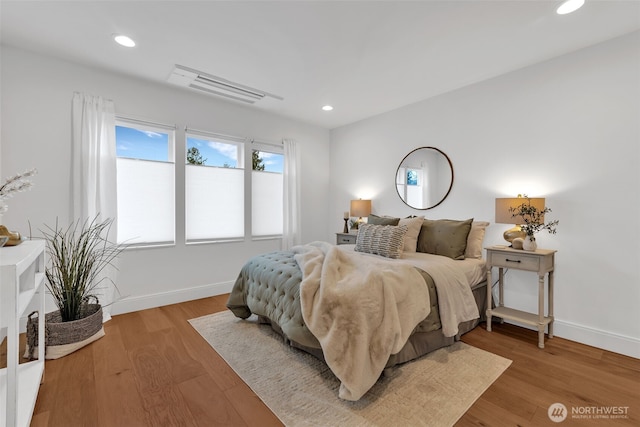 bedroom with light wood-type flooring, baseboards, and recessed lighting