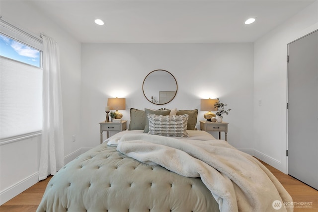 bedroom with recessed lighting, light wood-style flooring, and baseboards