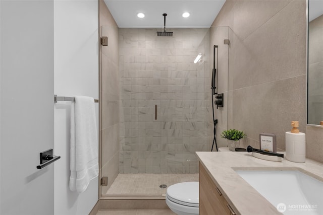 bathroom featuring recessed lighting, toilet, a shower stall, and vanity