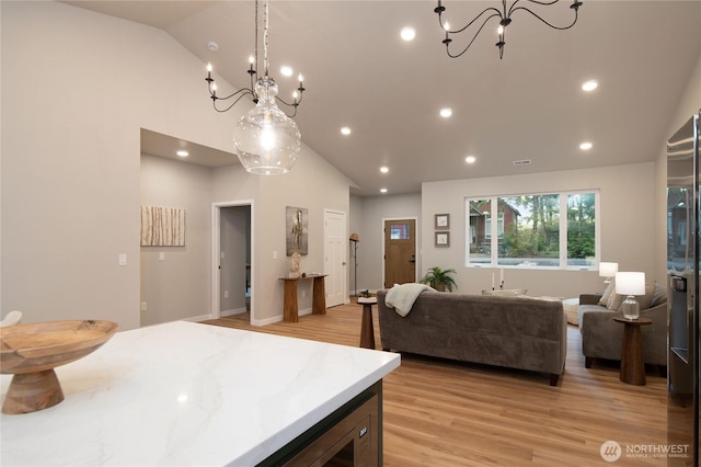 kitchen featuring light wood-type flooring, a notable chandelier, and recessed lighting