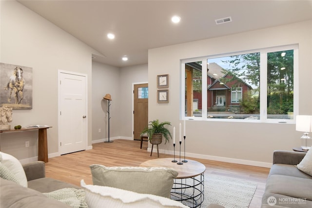 living room featuring recessed lighting, visible vents, baseboards, and wood finished floors