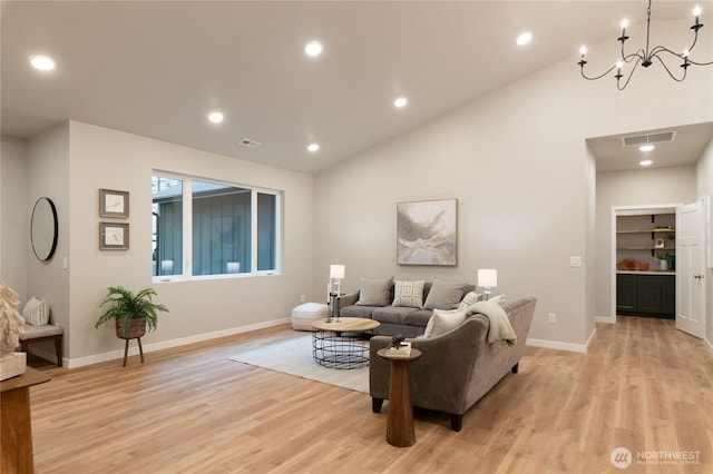 living room with light wood-type flooring, visible vents, and recessed lighting