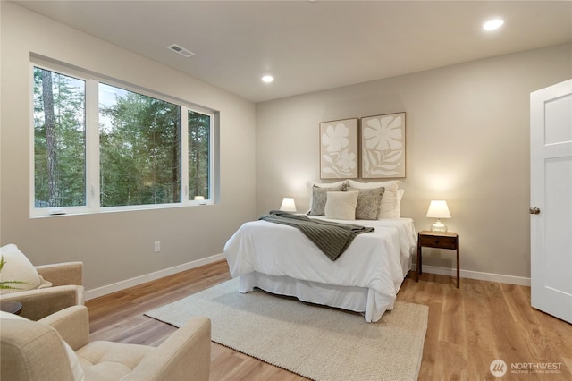 bedroom featuring recessed lighting, light wood-type flooring, and baseboards