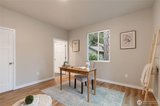 office featuring baseboards and wood finished floors