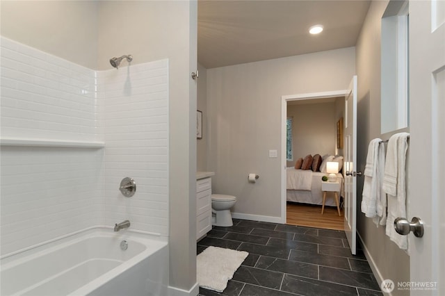 ensuite bathroom with connected bathroom, toilet, vanity, baseboards, and shower / bathing tub combination