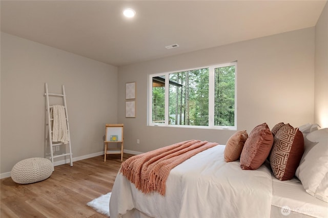 bedroom with recessed lighting, visible vents, light wood-style flooring, and baseboards