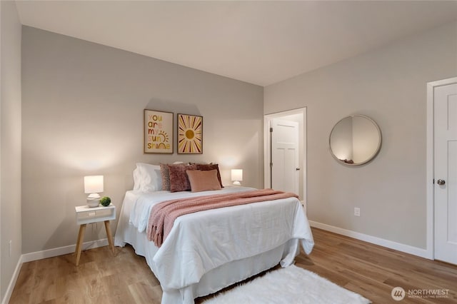 bedroom featuring light wood-type flooring and baseboards