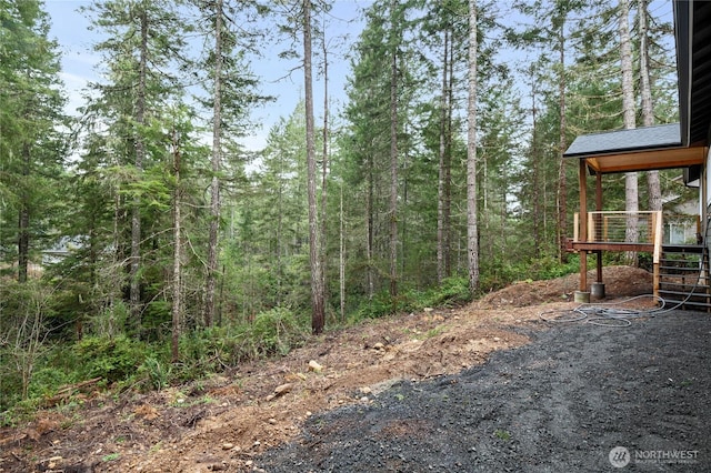 view of yard with a view of trees