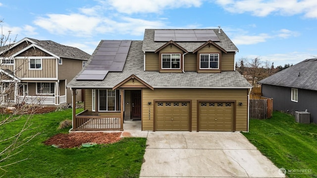 view of front of house with a porch, an attached garage, a front yard, cooling unit, and driveway