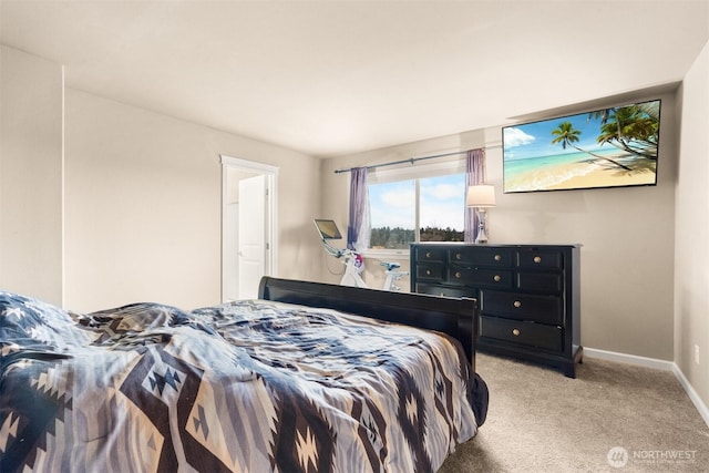 bedroom with light carpet and baseboards