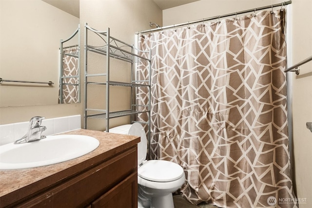 full bathroom with toilet, a shower with shower curtain, and vanity