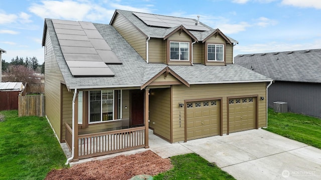 view of front of property featuring a shingled roof, covered porch, roof mounted solar panels, and central AC unit