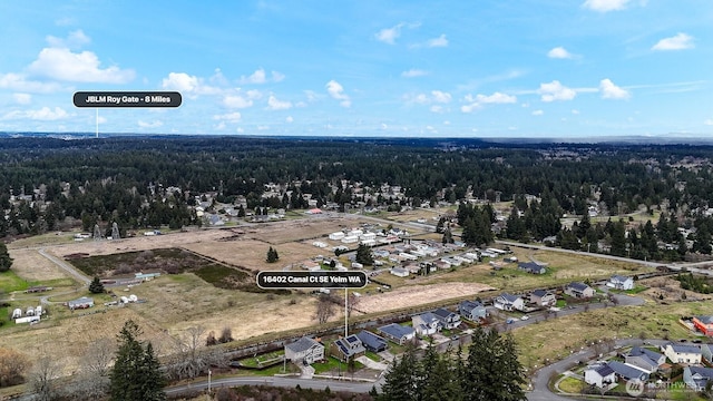 birds eye view of property with a forest view