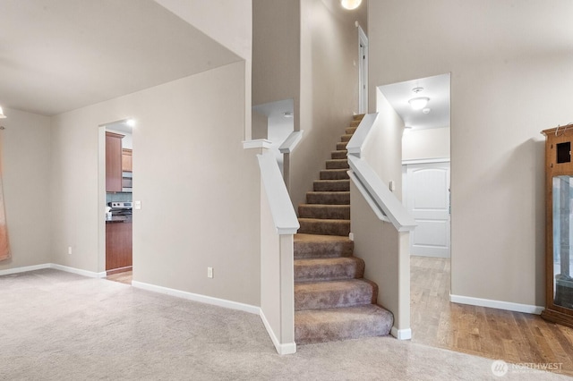 staircase featuring carpet floors and baseboards