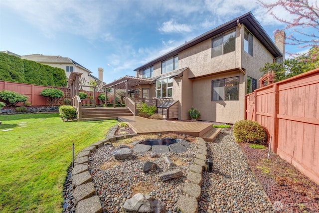 rear view of house with a wooden deck, a yard, a fenced backyard, and a pergola