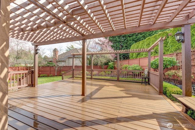 deck featuring a pergola and a fenced backyard