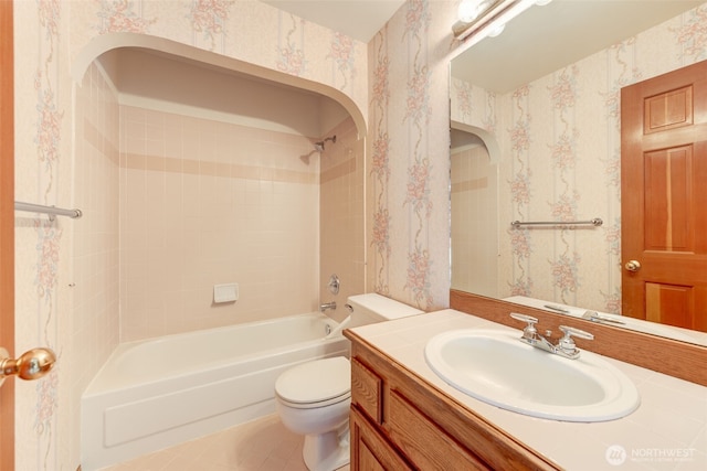 full bath featuring tub / shower combination, wallpapered walls, toilet, tile patterned floors, and vanity