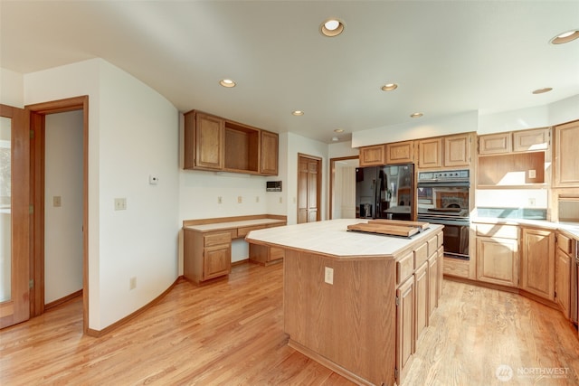 kitchen featuring black appliances, a center island, tile countertops, recessed lighting, and light wood-style floors