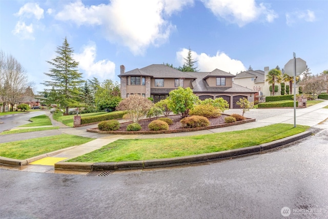 view of front of property featuring driveway, a chimney, and a front yard