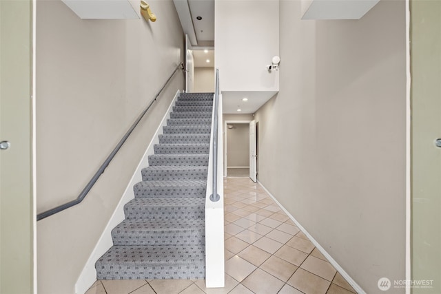 stairs featuring tile patterned flooring and baseboards