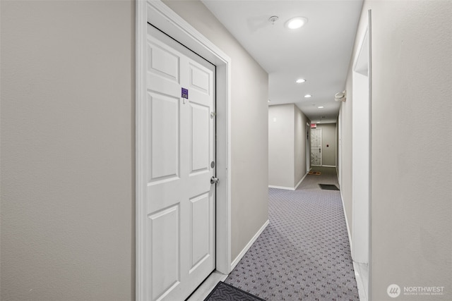 corridor featuring recessed lighting, light carpet, and baseboards