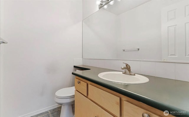 bathroom with toilet and vanity